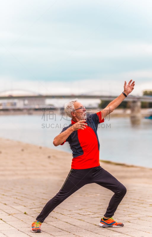 Senior man stretching outdoors