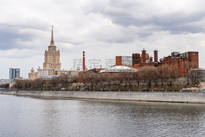A red brick wall factory and  the Hotel Ukraina, or Radisson Royal Hotel, at the bank of the Moskva River, in Moscow, Russia. One the famous seven buildings in Moscow that are known as “Stalinist skyscrapers”.