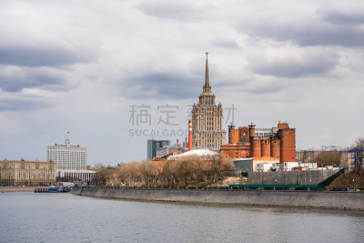 A red brick wall factory and  the Hotel Ukraina, or Radisson Royal Hotel, at the bank of the Moskva River, in Moscow, Russia. One the famous seven buildings in Moscow that are known as “Stalinist skyscrapers”.