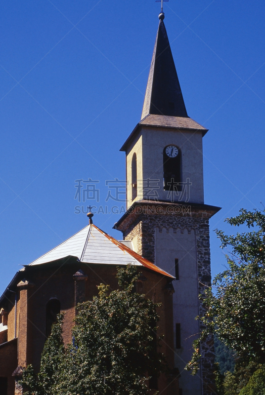 Resort town of Le Bourg-d'Oisans. A commune in the Isère department in southeastern France. It is located in the Oisans region of the French Alps. It is a warm sunny day in summer. This is the local Church.