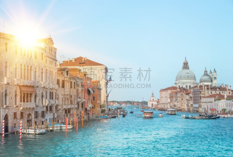 Sun flash and old cathedral of Santa Maria della Salute. The colorful venice view for historic architecture background.